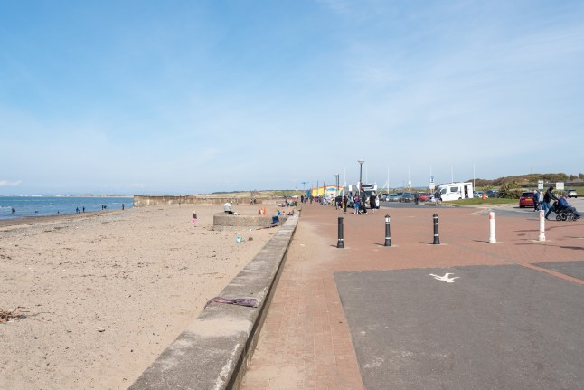 Prestwick, Scotland, UK - April 16, 2021: The beach and shore area of Prestwick on the first day of lockdown restrictions being relaxed with people glad to be out mixing with families in the Scottish fresh air.