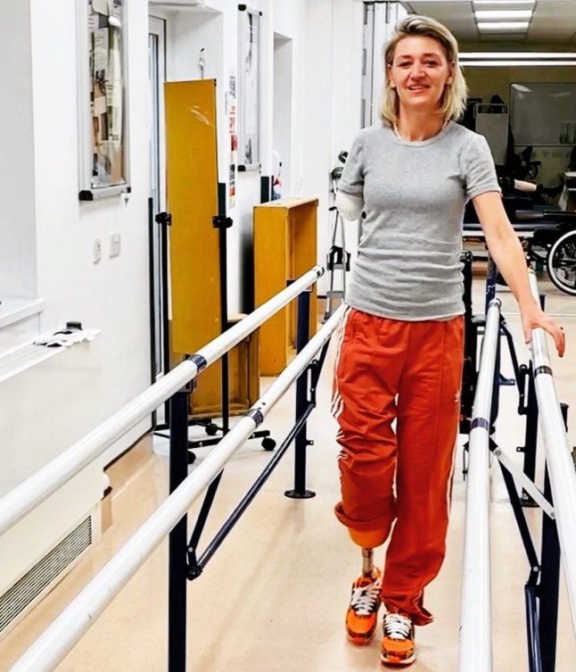Sarah walking in hospital as part of her recovery.