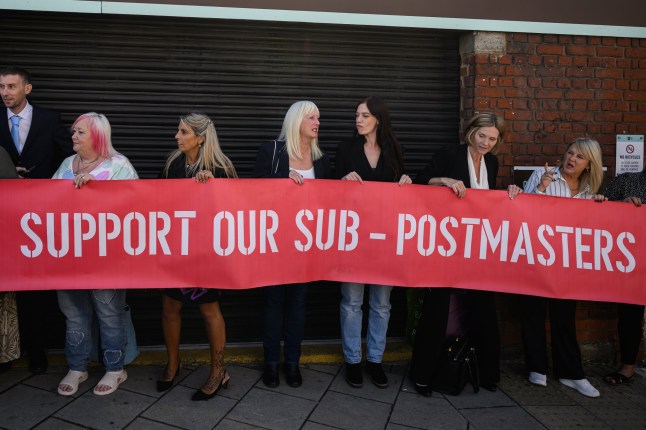 LONDON, ENGLAND - JULY 08: A group of those affected by the Horizon IT issue hold a banner, as the first volume of a report from the Post Office Horizon IT Inquiry is announced at The Kia Oval on July 08, 2025 in London, England. The first part of the report from the inquiry, which began in 2022 and is chaired by Sir Wyn Williams, will focus on compensation for sub-postmasters wrongly accused of financial improprieties that were in fact caused by Post Office's faulty Horizon computer system. More than 900 people were prosecuted for related crimes and 236 of them were imprisoned, in what is considered one of the largest miscarriages of justice in UK history. A second part of the inquiry's report will focus on who's to blame. (Photo by Leon Neal/Getty Images)