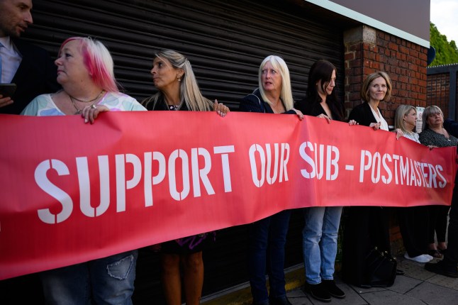 LONDON, ENGLAND - JULY 08: A group of those affected by the Horizon IT issue hold a banner, as the first volume of a report from the Post Office Horizon IT Inquiry is announced at The Kia Oval on July 08, 2025 in London, England. The first part of the report from the inquiry, which began in 2022 and is chaired by Sir Wyn Williams, will focus on compensation for sub-postmasters wrongly accused of financial improprieties that were in fact caused by Post Office's faulty Horizon computer system. More than 900 people were prosecuted for related crimes and 236 of them were imprisoned, in what is considered one of the largest miscarriages of justice in UK history. A second part of the inquiry's report will focus on who's to blame. (Photo by Leon Neal/Getty Images)