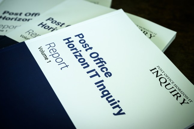 LONDON, ENGLAND - JULY 08: In this photo illustration, copies of the first volume of a report from the Post Office Horizon IT Inquiry are displayed at The Kia Oval on July 08, 2025 in London, England. The first part of the report from the inquiry, which began in 2022 and is chaired by Sir Wyn Williams, will focus on compensation for sub-postmasters wrongly accused of financial improprieties that were in fact caused by Post Office's faulty Horizon computer system. More than 900 people were prosecuted for related crimes and 236 of them were imprisoned, in what is considered one of the largest miscarriages of justice in UK history. A second part of the inquiry's report will focus on who's to blame. (Photo by Leon Neal/Getty Images)