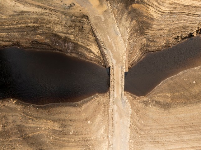 Dry cracked earth at Baitings Reservoir in Ripponden, West Yorkshire. Households in Yorkshire have become the first to be hit with a hosepipe ban by Yorkshire Water, after months of extremely hot and dry weather across England. Picture date: Wednesday July 9, 2025. PA Photo. Photo credit should read: Danny Lawson/PA Wire