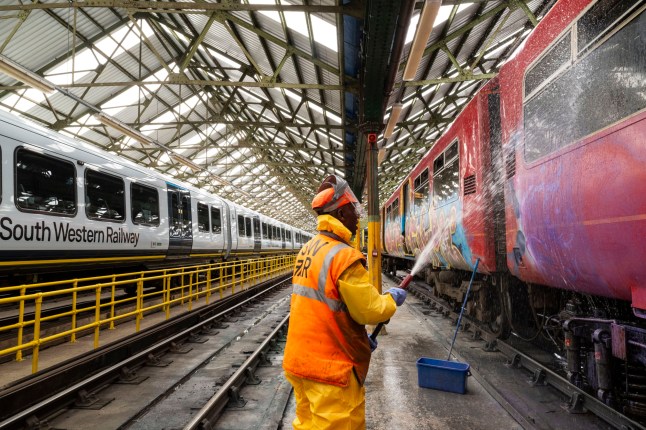 Train presentation teams clean the trains before service during Wimbledon at the Southwestern Railways Wimbledon depot. Picture: Jeff Asiedu - train presentation operative cleans graffiti from a Southwestern train. ?? Lucy Young 2025 07799118984 lucyyounguk@gmail.com www.lucyyoungphotos.co.uk