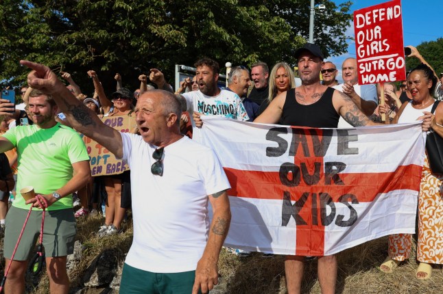 ? Licensed to London News Pictures. 13/07/2025. Epping, UK. Local residents gather outside The Bell hotel in Epping, Essex, England, to protest against the hotel?s housing of migrants. Protesters and parts of the local community are raising concerns about an alleged sexual assault carried out by a migrant in Epping last week. Photo credit: Jacqueline Lawrie/LNP