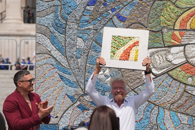 World Heavyweight Champion boxer Oleksandr Usyk and Sir Richard Branson unveil the Kestrel Mosaic, a faithful recreation of a 1967 mosaic by Ukrainian artist Alla Horska, whose original work in Mariupol was damaged during Russia's invasion, at Trafalgar Square, London. Picture date: Monday July 14, 2025. PA Photo. Photo credit should read: Yui Mok/PA Wire