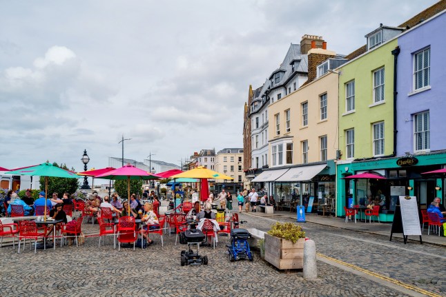 Margate, UK - Sep 7 2022 Tourists and locals enjoy the restaurants, cafes and boutiques along The Parade in Margate Old Town.