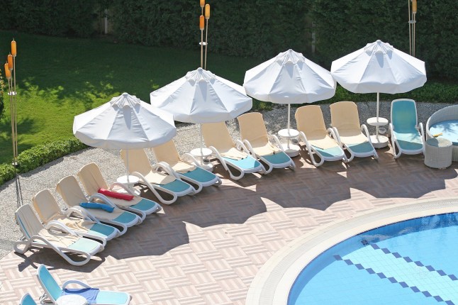 towels reserving sun lounger at a hotel pool in Belek, Turkey, 07 12 2017; Shutterstock ID 1032310261; purchase_order: -; job: -; client: -; other: -