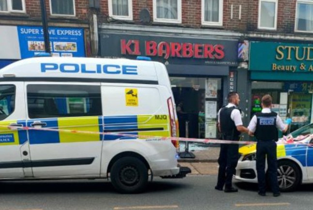 A serious incident on Sutton High Street has prompted a large response from the Metropolitan Police and London Ambulance Service, including an air ambulance landing nearby at Sutton Green. The incident reportedly occurred at around 2:10pm outside K1 Barbers, where witnesses saw a man with blood on his face and multiple visible injuries. Graphic photos from the scene show blood-stained rags, belts, and smashed glass outside the premises. Emergency Services Respond to Major Incident on Sutton High Street Police cordoned off a section of the High Street while emergency responders worked at the scene. Officers were seen entering K1 Barbers, with a strong visible presence along the street. Emergency Services Respond to Major Incident on Sutton High Street In the aftermath d blood issplattered across the pavement, adding to the growing concern among local residents and shoppers. At this stage, official details remain limited, and the nature of the incident???whether a stabbing, assault, or another form of violence???has not been confirmed. No arrests or updates on the victim's condition have been released. A spokesperson for Metropolitan Police said they are aware of the incident and a statement is expected. The London Ambulance Service has also been approached for comment.