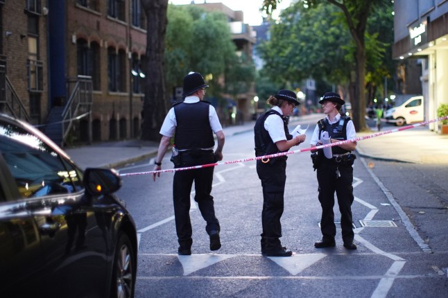 Police officers at the scene in Long Lane, Southwark, south London, where four people were stabbed earlier today. A 58-year-old man died at the scene while three other men were taken to hospital, where one aged 27 has since died. Picture date: Monday July 28, 2025. PA Photo. Photo credit should read: James Manning/PA Wire