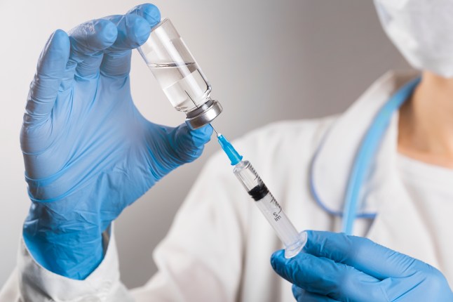 Nurse preparing a vaccine syringe