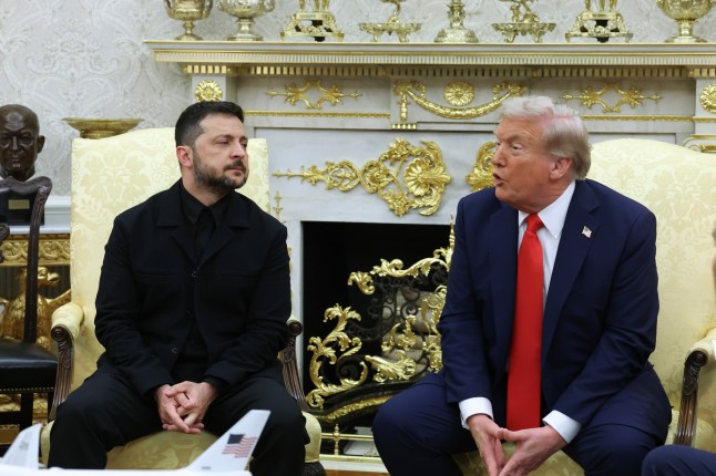 Volodymyr Zelensky looking over at Donald Trump from his seat, as Trump speaks in the White House's Oval Office.