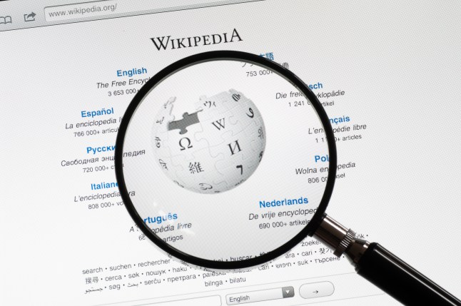 Wikipedia page with a magnifying glass being held over the top of it