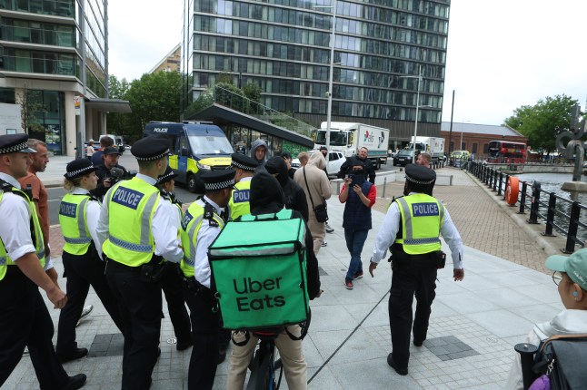This is the moment an asylum seeker gives protesters the finger as he enters a migrant hotel. He was being escorted by a police officer into The Chine Hotel in Bournemouth, Dorset, when 40 protesters stood outside the premises started shouting abuse at him. The migrant stops in his tracks and turns around to give the man the unsavoury hand gesture before a second police officer gets involved as tensions flare. The late 19th century hotel on the seafront was once a favourite of celebrities including Stan Laurel, Oliver Hardy and Vera Lynn.