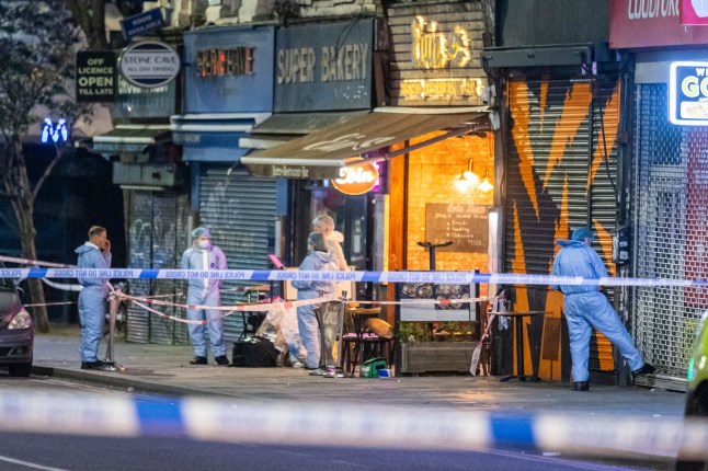 ?? Licensed to London News Pictures. 30/05/2024. London, UK. Forensic officers gather evidence at the scene in Dalston, east London. Police were called at 9:20hrs on Wednesday, 29 May to reports of a shooting near a restaurant in Kingsland High Street, Dalston, east London. Three adults and a child were found with gunshot injuries at the scene. They were all taken to an east London hospital. The child remains in a serious condition and we await further details of the other victims' conditions. Photo credit: Marcin Nowak/LNP