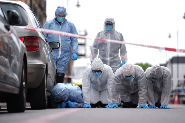 Police forensic officers in Dalston, east London, near to the scene of a shooting at Kingsland High Street, Hackney, east London, where three adults and a child have been injured. The Metropolitan Police have said the child is in a serious condition and that they are awaiting updates on the condition of the adults. Police said they were called to the scene at around 9.20pm on Wednesday with specialist firearms officers attending. Picture date: Thursday May 30, 2024. PA Photo. See PA story POLICE Hackney. Photo credit should read: James Manning/PA Wire