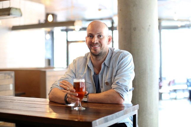 James Watt, chief executive officer of Brewdog Plc, poses for a photograph at the company's bar in Shoreditch, London, U.K., on Tuesday, Sept. 1, 2015. The craft beer brewers have raised more than ??10 million in a crowdfunding project in which more than 35,000 people have invested, according to a statement on the company's website. Photographer: Chris Ratcliffe/Bloomberg via Getty Images