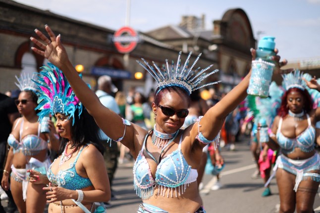 A reveller gestures during the Notting Hill Carnival parade, in London, Britain, on August 26, 2024. REUTERS/Hollie Adams