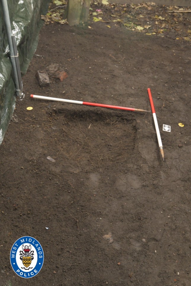 A photograph of the burial site where Abiyah's remains were discovered, showing a patch of dirt and police markers.