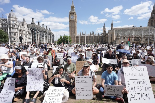 Supporters of Palestine Action take part in a mass action in Parliament Square, Westminster, central London, organised by Defend Our Juries as part of the Lift the Ban campaign, to end the proscription of Palestine Action. Picture date: Saturday August 9, 2025. PA Photo. Photo credit should read: Stefan Rousseau/PA Wire