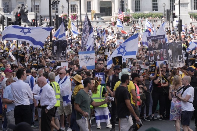People hold placards and wave Israeli flags during the National March For The Hostages near Trafalgar Square, central London, with family members of hostages being held by Hamas terrorists, Jewish community leaders and antisemitism campaigners taking part. Picture date: Sunday August 10, 2025. PA Photo. Photo credit should read: Stefan Rousseau/PA Wire