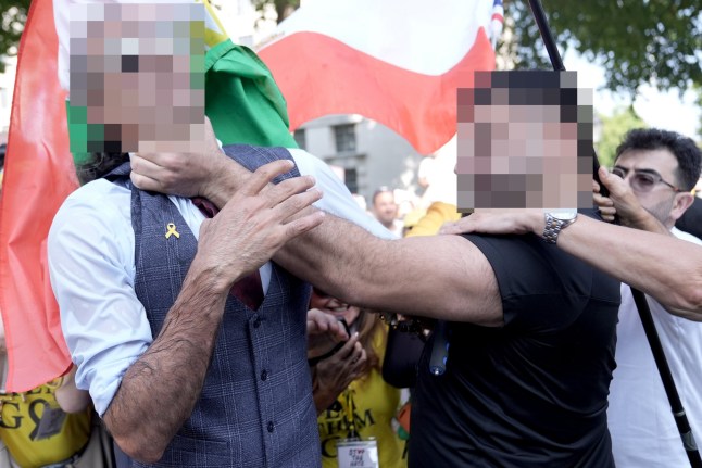 A man (left) taking part in the march is grabbed by the throat by another man, who was detained by police following the incident, during the National March For The Hostages, in central London, in support of family members of hostages being held by Hamas terrorists. Picture date: Sunday August 10, 2025. PA Photo. Photo credit should read: Stefan Rousseau/PA Wire