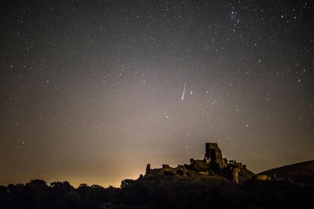 CORFE CASTLE, UNITED KINGDOM - AUGUST 12: A Perseid Meteor flashes across the night sky above Corfe Castle on August 12, 2016 in Corfe Castle, United Kingdom. The Perseids meteor shower occurs every year when the Earth passes through the cloud of debris left by Comet Swift-Tuttle, and appear to radiate from the constellation Perseus in the north eastern sky. (Photo by Dan Kitwood/Getty Images)