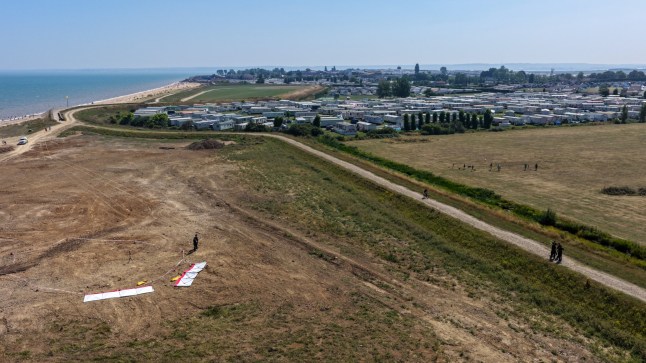 A field in Leysdown-on-Sea, Kent, with a beach in the distance.