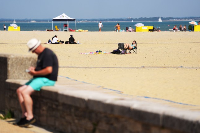 Visitors relax on the seafront at Ryde, Isle of Wight. Amber heat health warnings have been issued across large swathes of England, as temperatures are expected to soar. Picture date: Tuesday August 12, 2025. PA Photo. Areas of the UK are expected to be hotter than Bali in the coming days, with thermometer readings forecast to hit the mid-30s on Tuesday. Photo credit should read: Jonathan Brady/PA Wire