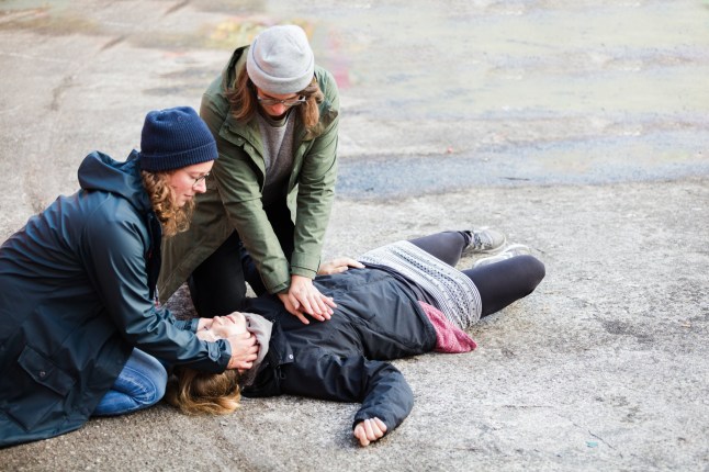 Two woman performing reanimation of another woman