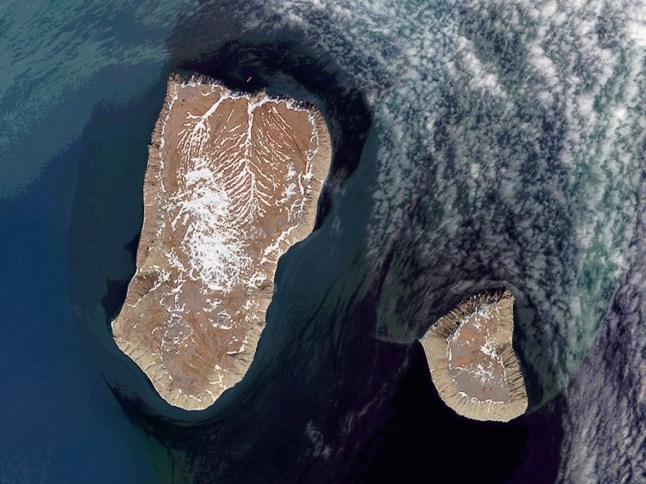 DIOMEDE ISLANDS, BERING STRAIT - 14 JUNE 2017: (SOUTH AFRICA OUT) The Diomede Islands in the Bering Strait are separated by the International Date Line with Big Diomede Island (Russia) 21 hours ahead of Little Diomede (United States) on June 14, 2017 in Diomede Islands, Bering Strait. (Photo by Orbital Horizon/Copernicus Sentinel Data 2018/Gallo Images/Getty Images)