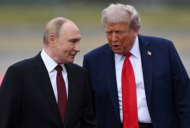 In this pool photograph distributed by the Russian state agency Sputnik, US President Donald Trump and Russian President Vladimir Putin talk on the tarmac upon their arrival for a US-Russia summit on Ukraine at Joint Base Elmendorf-Richardson in Anchorage, Alaska, on August 15, 2025. (Photo by Sergey Bobylev / POOL / AFP) (Photo by SERGEY BOBYLEV/POOL/AFP via Getty Images)