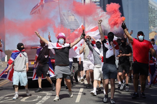 ??George Cracknell Wright 17/08/2025 London, United Kingdom Pink Ladies Anti Asylum Hotel Protest Protesters from the anti asylum hotel group the Pink Ladies join masked protesters with flares to block the Blue Bridge on the Isle of Dogs to demonstrate their opposition to the housing of asylum seekers in the Britannia International Hotel in Canary Wharf, east London. Photo Credit: George Cracknell Wright