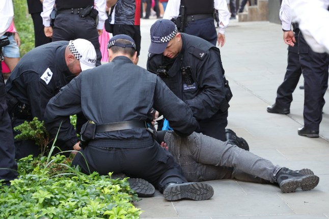 ??George Cracknell Wright 17/08/2025 London, United Kingdom Pink Ladies Anti Asylum Hotel Protest Police make arrests during an anti migrant protest outside the Britannia International Hotel in Canary Wharf, east London. Photo Credit: George Cracknell Wright