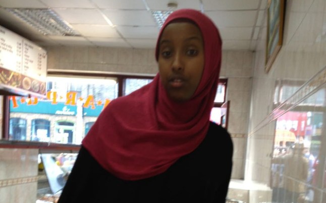 Zahwa Salah Mukhtar is seen pictured in a takeaway wearing a pink headscarf and a black top