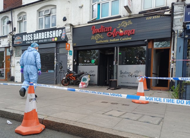 A forensic investigator at a restaurant in Ilford, east London after three people are in a life-threatening condition after a suspected arson attack. Police, paramedics and firefighters were called to the scene in Woodford Avenue, Gants Hill, at about 9pm on Friday. Part of the ground floor was damaged by fire and crews rescued five people from the restaurant, while nine others got out beforehand, London Fire Brigade said. Picture date: Saturday August 23, 2025. PA Photo. Photo credit should read: Helen William/PA Wire