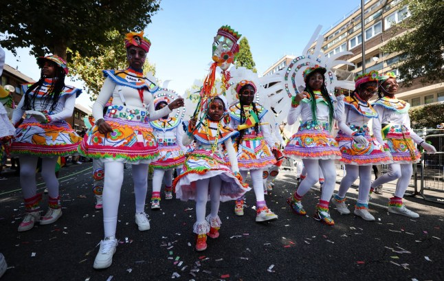 epa12319741 Participants during the Notting Hill Carnival Children's Day Parade in London, Britain, 24 August 2025. The Notting Hill Carnival is the largest street carnival in Europe. It is a community-led celebration of Caribbean history and culture. This year, it will run from August 25 to 26. Sunday is traditionally the children's carnival day. EPA/ANDY RAIN .