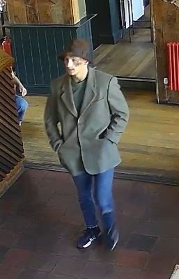 A burglar on the run and wanted by police has been spotted - in the pub. Jon Michael Lee, 24, (pictured) is being sought for escape from lawful custody after he was arrested on suspicion of driving offences and burglary. Officers have released CCTV images of Lee inside the Up in Arms Pub in Oxford at around 4.30pm on Friday August 22. The images show him wearing a pair of black Nike trainers, skinny ripped jeans, a grey blazer, green t-shirt, and a brown hat. Photo released 24/08/2025