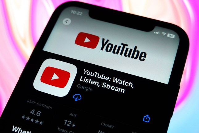 In this photo illustration, the YouTube logo is displayed in the Apple Store on an iPhone.