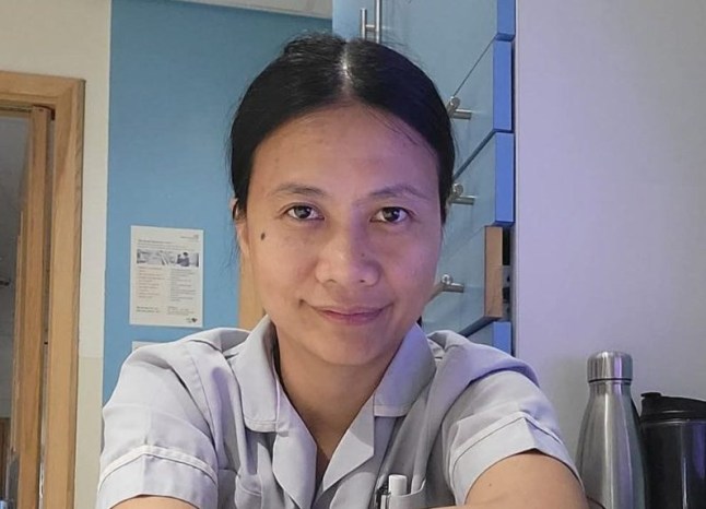 Healthcare worker Apple smiles in a photo.