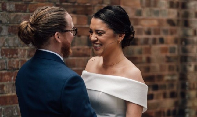 Joseph and Cate facing each other during their wedding.
