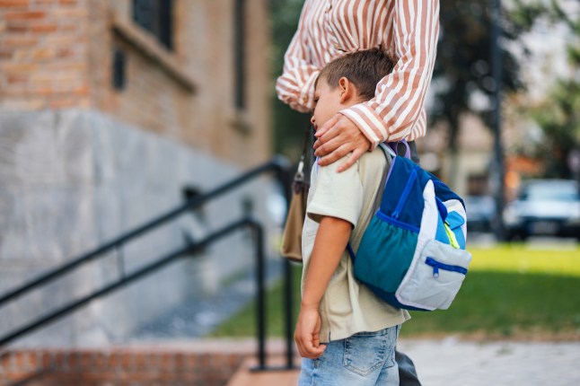 Mother Comforting Her Son on First Day of School