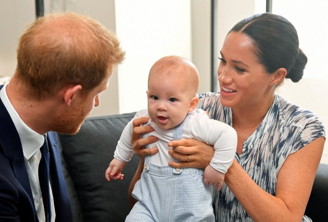 Prince Harry and Meghan holding their son Archie in Cape Town, South Africa, in 2019.