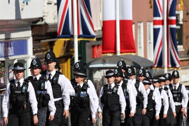 British police officers take place in a street of Windsor, west of London, on July 8, 2025, ahead of the first day of France's President three-day state visit to Britain. (Photo by Ludovic MARIN / AFP) (Photo by LUDOVIC MARIN/AFP via Getty Images)