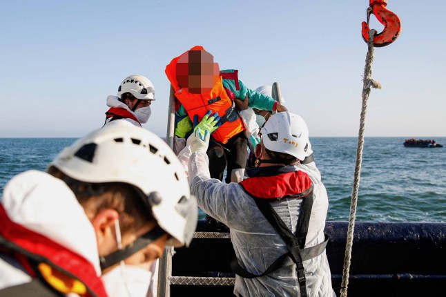 TOPSHOT - A girl cries as migrants are rescued by crew members of the Abeille Languedoc ship after their boat's generator broke down in French waters while they were trying to cross the Channel illegally to Britain, off the coasts of Boulogne-sur-Mer, northern France, on May 9, 2022. - The Abeille Languedoc is an ocean-going tug specializing in the rescue of ships in distress, and which has been moored in Cherbourg for 26 years, monitoring the Channel between the Cotentin and the Pas-de-Calais. (Photo by Sameer Al-DOUMY / AFP) (Photo by SAMEER AL-DOUMY/AFP via Getty Images)