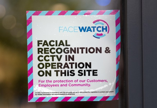 2A1FHMR A supermarket door Facewatch warning sign. Facewatch is an automatic facial recognition system that uses a digital camera to compare images of anyone entering the supermarket to a cloud based database of images of individuals that could be a threat to the supermarket, its staff or customers. Credit: Stephen Bell/Alamy