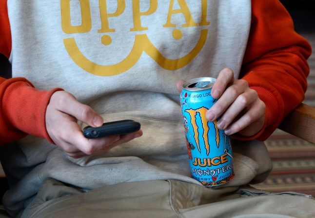 ALBUQUERQUE, NEW MEXICO - FEBRUARY 25, 2019: A Southwest Airlines passenger uses his smartphone and drinks a can of Monster Energy Juice as he sits in the terminal at Albuquerque International Sunport in Albuquerque, New Mexico. (Photo by Robert Alexander/Getty Images)