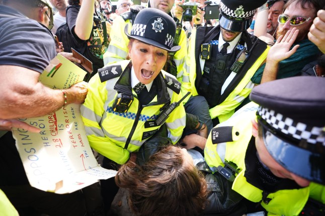 A demonstrator is led away by police officers as people take part in a Lift the Ban on Palestine Action protest organised by Defend our Juries in Parliament Square in London. Picture date: Saturday September 6, 2025. PA Photo. Photo credit should read: James Manning/PA Wire