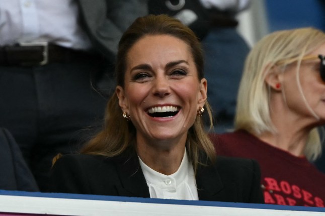 Britain's Catherine, Princess of Wales attends the Women's Rugby World Cup at Brighton & Hove Albion Stadium, wearing a dark jacket and white top.