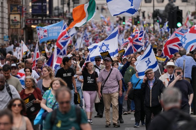 Protesters hold placards and wave flags during a 'march against antisemitism' demonstration in central London, on September 7, 2025, (Photo by CARLOS JASSO / AFP) (Photo by CARLOS JASSO/AFP via Getty Images)