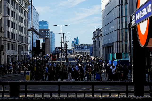 Commuters cross London Bridge early in the morning of September 8, 2025, as most of London Underground services are suspended during strike action by members of the Railway workers' union RMT. London has been hit by a week-long strike on its underground railway the Tube, after unions and management failed to reach a pay deal. Thousands of Tube staff are to carry out the network's biggest strike for three years, with the worst of the disruption expected Monday to Thursday. (Photo by CARLOS JASSO / AFP) (Photo by CARLOS JASSO/AFP via Getty Images)